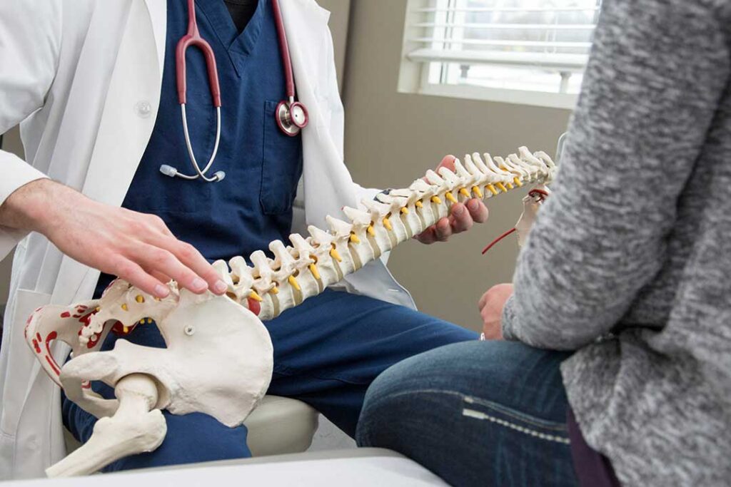 A patient in comfortable clothing completing medical forms in a clinic waiting area.